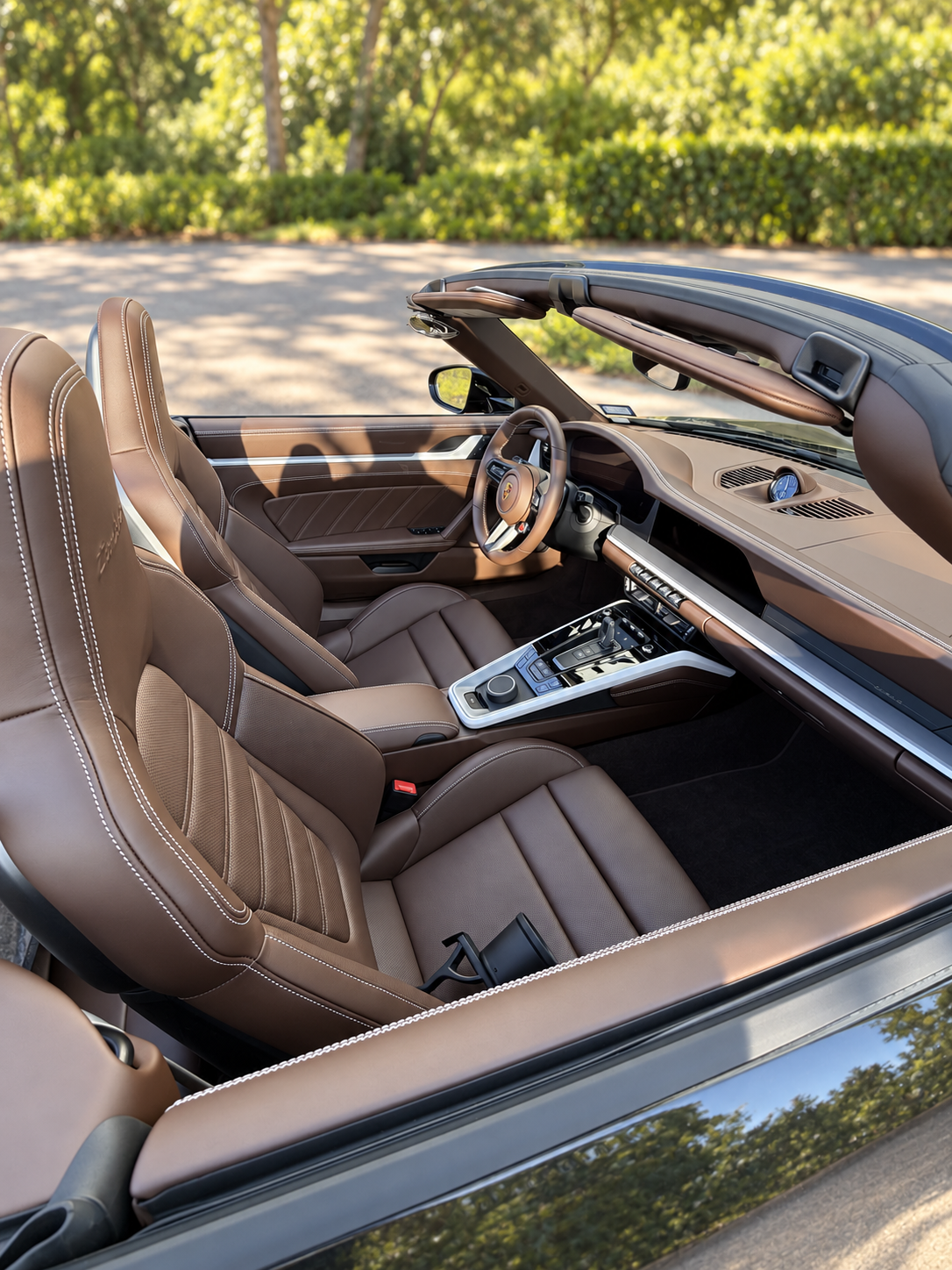 Wide view of the Truffle Brown Club Leather cabin with the convertible top lowered