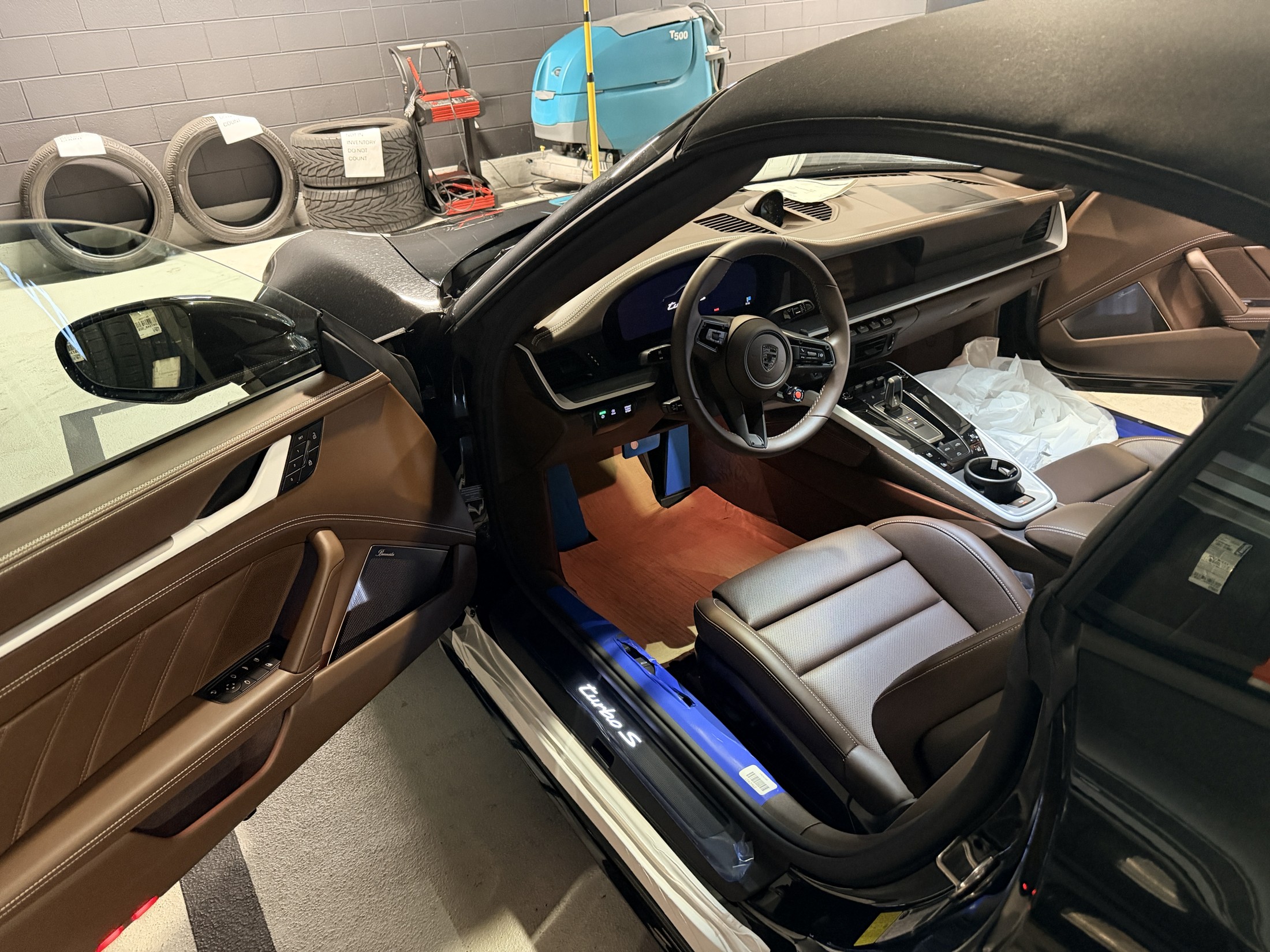 Full cockpit view showing the Truffle Brown Club Leather interior, dashboard and driver seat