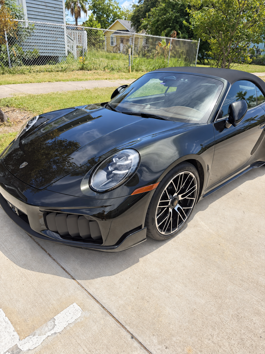Front three-quarter view of the Dark Olive Green Porsche 911 Turbo S Cabriolet