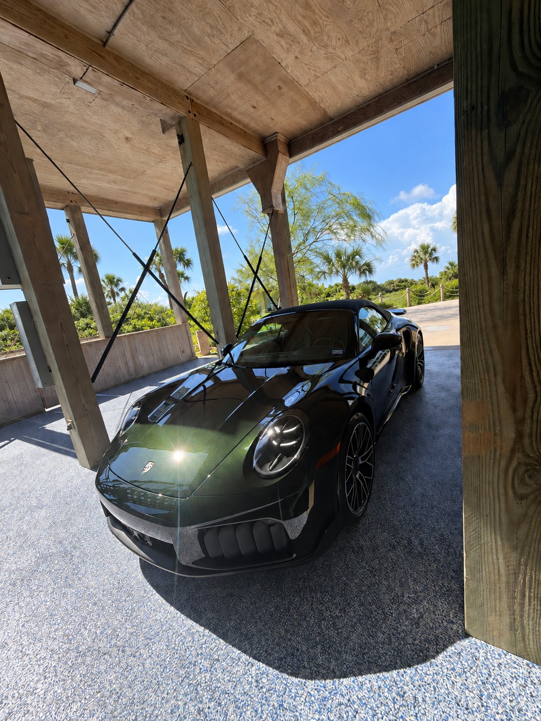 Full front three-quarter view showing the Paint to Sample Dark Olive Green Metallic finish in direct sunlight