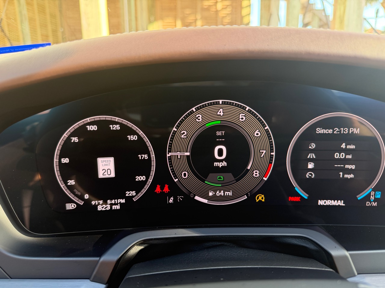 Digital instrument cluster showing 823 indicated miles
